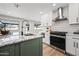 Bright kitchen features a large island, white cabinets, stainless steel appliances, and decorative backsplash at 1012 E Magdalena Dr, Tempe, AZ 85283
