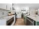 Bright kitchen offers stainless steel appliances, white cabinets, an island, and marble countertops at 1012 E Magdalena Dr, Tempe, AZ 85283