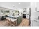 Bright kitchen with a large island, seating, white cabinets, stainless steel appliances, and wood floors at 1012 E Magdalena Dr, Tempe, AZ 85283