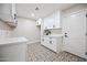 Bright laundry room features white cabinets, designer tile floor and ample counter space at 1012 E Magdalena Dr, Tempe, AZ 85283