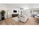 Spacious living room boasts hardwood floors, light neutral walls, a modern ceiling fan, and backyard access at 1012 E Magdalena Dr, Tempe, AZ 85283