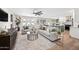 Bright living room featuring hardwood floors, modern furniture, and an open layout with seamless flow into the kitchen at 1012 E Magdalena Dr, Tempe, AZ 85283