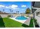 Inviting backyard oasis with a sparkling pool, lush turf, and comfortable lounge area at 1012 E Magdalena Dr, Tempe, AZ 85283