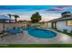 Backyard with pool, artificial turf, and a lounging area with a colorful sunset at 1012 E Magdalena Dr, Tempe, AZ 85283
