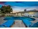 Charming backyard oasis with a sparkling pool, artificial turf, and comfortable lounge chairs at 1012 E Magdalena Dr, Tempe, AZ 85283