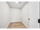 Practical storage room with hardwood floors, a smooth ceiling, and a white door for easy access and organization at 1012 E Magdalena Dr, Tempe, AZ 85283