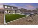 Expansive backyard featuring a pool, hot tub, synthetic grass, and beautiful landscaping at 10792 W Whitehorn Way, Peoria, AZ 85383