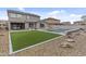 A backyard with artificial turf, a pool with attached spa, and a covered patio perfect for outdoor living at 10792 W Whitehorn Way, Peoria, AZ 85383