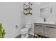 Modern bathroom featuring sleek vanity, round mirror, and industrial-style shelving at 10792 W Whitehorn Way, Peoria, AZ 85383
