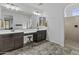 Spacious bathroom featuring dual sinks, vanity, tile flooring, and a walk-in shower at 10792 W Whitehorn Way, Peoria, AZ 85383