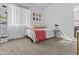 Well-lit bedroom with shelving, carpet and a comfortable bed with a pink blanket at 10792 W Whitehorn Way, Peoria, AZ 85383