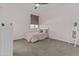 Cozy bedroom with plush carpet, a ceiling fan, and a comfortable bed with decorative pillows at 10792 W Whitehorn Way, Peoria, AZ 85383