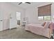 Bright bedroom with plush carpet, large window, and a comfortable bed with decorative pillows at 10792 W Whitehorn Way, Peoria, AZ 85383
