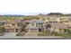 View of a 2-story home with a three-car garage, desert landscaping, and a stone and stucco facade at 10792 W Whitehorn Way, Peoria, AZ 85383