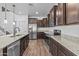 Modern kitchen with stainless steel appliances, granite counters and dark wood cabinets at 10792 W Whitehorn Way, Peoria, AZ 85383
