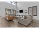 Bright living room with soaring ceilings, modern furnishings, clerestory windows, and wood-look flooring at 10792 W Whitehorn Way, Peoria, AZ 85383