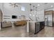 Light-filled open floorplan with high ceilings, seamlessly connects the living room, kitchen and staircase at 10792 W Whitehorn Way, Peoria, AZ 85383