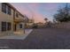 Large gravel backyard featuring a covered patio, second story balcony, and privacy wall at 10866 S Dreamy Dr, Goodyear, AZ 85338