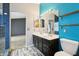 Bathroom featuring a double sink vanity and a toilet, showcasing modern fixtures and a blue accent wall at 10866 S Dreamy Dr, Goodyear, AZ 85338