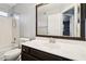 Cozy bathroom with a shower-tub combo, vanity, and decorative mirror at 10866 S Dreamy Dr, Goodyear, AZ 85338