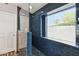 Bathroom featuring glass enclosed shower, stylish tile, and eye-catching window view at 10866 S Dreamy Dr, Goodyear, AZ 85338