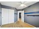 Bedroom features a ceiling fan, a closet with sliding doors, and a doorway to the upstairs hallway at 10866 S Dreamy Dr, Goodyear, AZ 85338