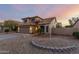 Exterior view of a two-story home with a tile roof, a two-car garage, and desert landscaping at 10866 S Dreamy Dr, Goodyear, AZ 85338