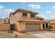 Charming two-story home boasting a tile roof, desert landscaping, and an attached two-car garage at 10866 S Dreamy Dr, Goodyear, AZ 85338