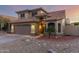 Exterior view of a two-story home with a tile roof, a two-car garage, and desert landscaping at 10866 S Dreamy Dr, Goodyear, AZ 85338