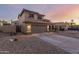 Exterior view of a two-story home with a tile roof, a two-car garage, and desert landscaping at 10866 S Dreamy Dr, Goodyear, AZ 85338
