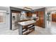 Well-equipped kitchen features stainless steel appliances, a central island, and wooden cabinetry at 10866 S Dreamy Dr, Goodyear, AZ 85338