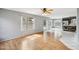 Open-concept living area with wood flooring leading to kitchen at 10866 S Dreamy Dr, Goodyear, AZ 85338