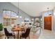 Open-concept living room featuring hardwood floors, neutral paint, dining area and a welcoming front door at 10866 S Dreamy Dr, Goodyear, AZ 85338