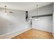 Spacious room featuring modern lighting, staircase access, and a combination of tiled and wood floors at 10866 S Dreamy Dr, Goodyear, AZ 85338