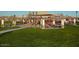 A playground with picnic tables sits on a manicured lawn within the community at 10866 S Dreamy Dr, Goodyear, AZ 85338