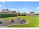 Expansive backyard featuring lush artificial grass, garden bed and well-manicured hedges at 11465 N 56Th St, Scottsdale, AZ 85254