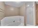 Bright bathroom featuring white tiled shower and bathtub with a glass door at 11465 N 56Th St, Scottsdale, AZ 85254