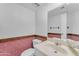 Pink bathroom featuring pink wallpaper, a toilet, and a vanity with a mirror at 11465 N 56Th St, Scottsdale, AZ 85254