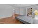 Bright bedroom featuring wood floors, a sliding glass door, and mirrored closet doors at 11465 N 56Th St, Scottsdale, AZ 85254