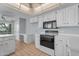 Bright kitchen featuring white cabinetry and appliances, as well as a desk area at 11465 N 56Th St, Scottsdale, AZ 85254