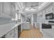 Bright kitchen featuring white cabinetry, countertops and appliances, and a classic tile floor at 11465 N 56Th St, Scottsdale, AZ 85254