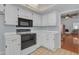 Bright kitchen with tile floors featuring white cabinets and modern appliances at 11465 N 56Th St, Scottsdale, AZ 85254