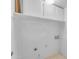 All-white laundry room with storage and hookups at 11465 N 56Th St, Scottsdale, AZ 85254