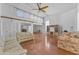 Open-concept living area features hardwood flooring, vaulted ceilings, and plentiful sunlight at 11465 N 56Th St, Scottsdale, AZ 85254