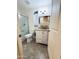 Bright bathroom featuring a framed mirror and granite-topped vanity and a shower with glass door at 12221 S Paiute St, Phoenix, AZ 85044