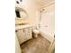 Bright bathroom featuring a granite-topped vanity, tile floors, and a shower-tub combo at 12221 S Paiute St, Phoenix, AZ 85044