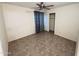 Bedroom features tile flooring, ceiling fan, and standard closet with mirrored doors at 12221 S Paiute St, Phoenix, AZ 85044