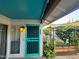 Inviting front porch featuring a teal-colored security door and a shaded outdoor garden area at 12221 S Paiute St, Phoenix, AZ 85044