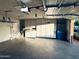 Well-lit garage features epoxy flooring and ample storage at 12221 S Paiute St, Phoenix, AZ 85044