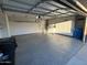 Well-lit garage features epoxy flooring and ample storage at 12221 S Paiute St, Phoenix, AZ 85044